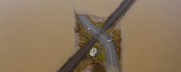 An overhead photo of a road submerged by floodwater.